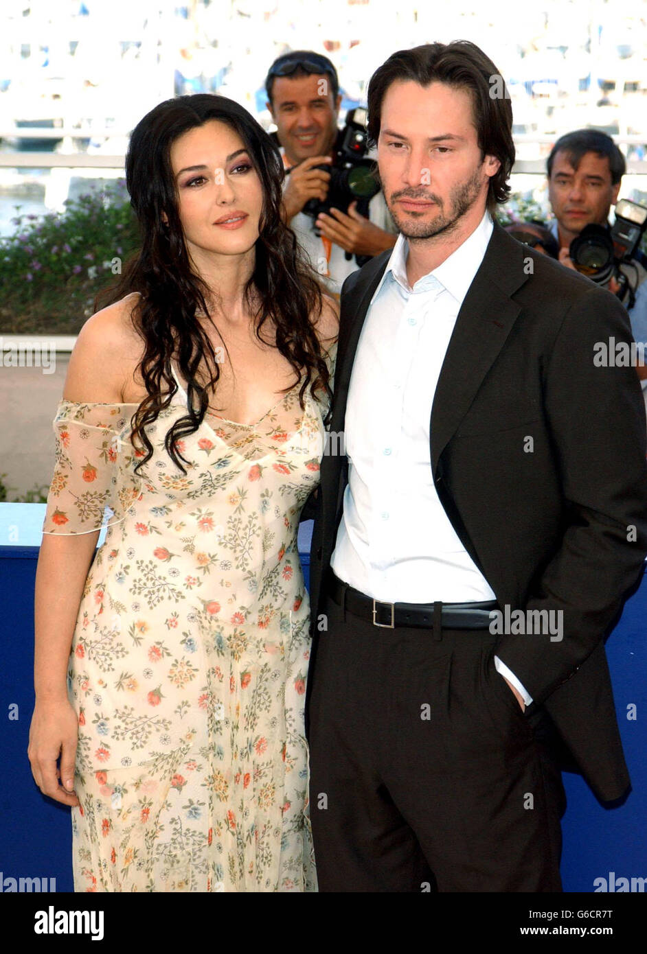 Actors Monica Bellucci and Keanu Reeves pose for photographers during a photocall to promote their new film The Matrix Reloaded at the Palias des Festival as part of the 56th Cannes Film Festival in southern France. Stock Photo