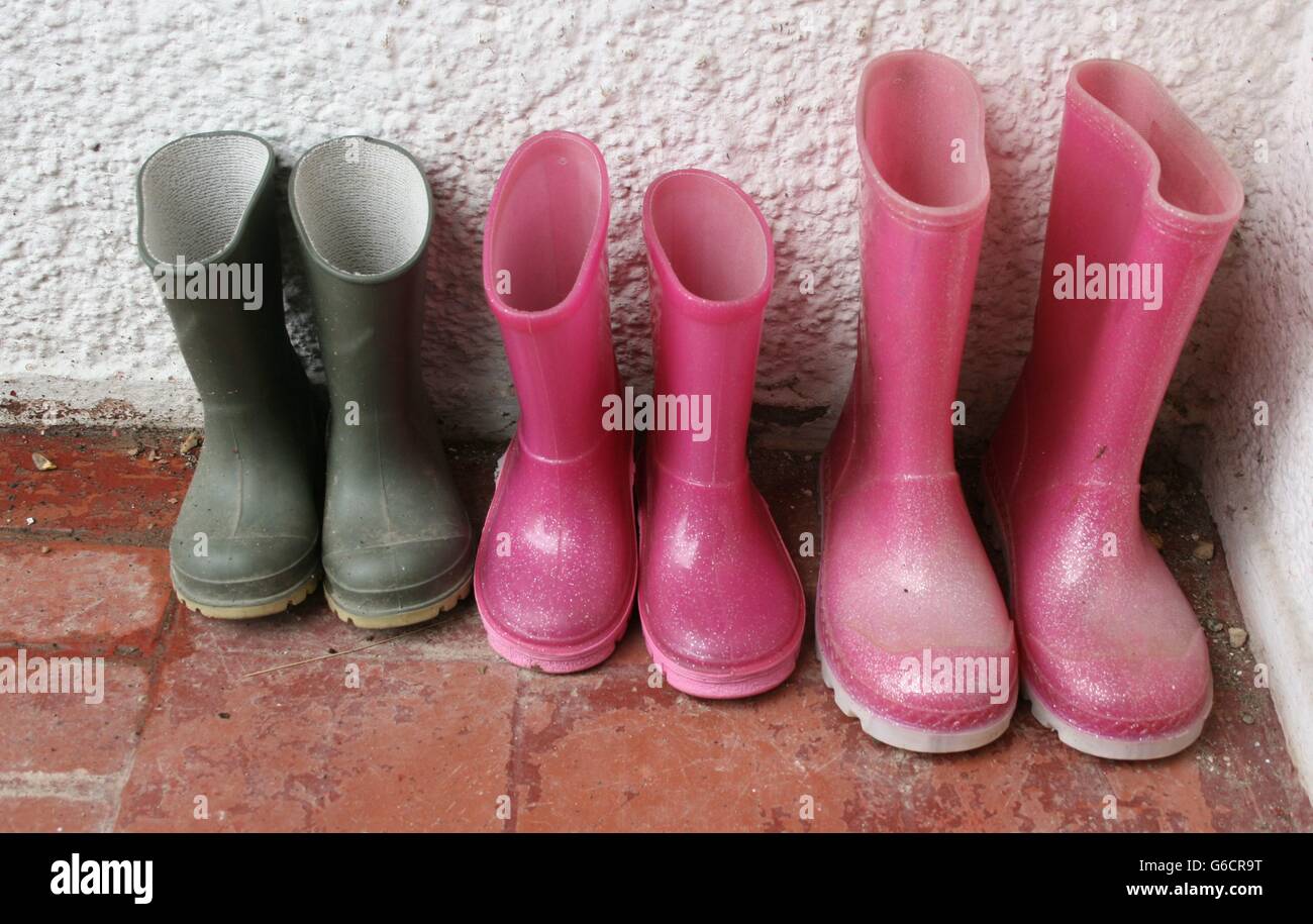 Wellies in a row: small, medium and large. Stock Photo