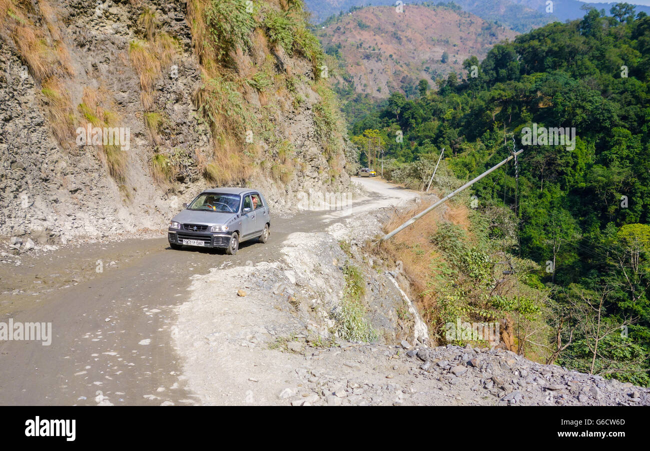 Maruti Suzuki Alto car on a bad patch of landslide prone winding mountain road en route to Pelling, Sikkim from Darjeeling Stock Photo