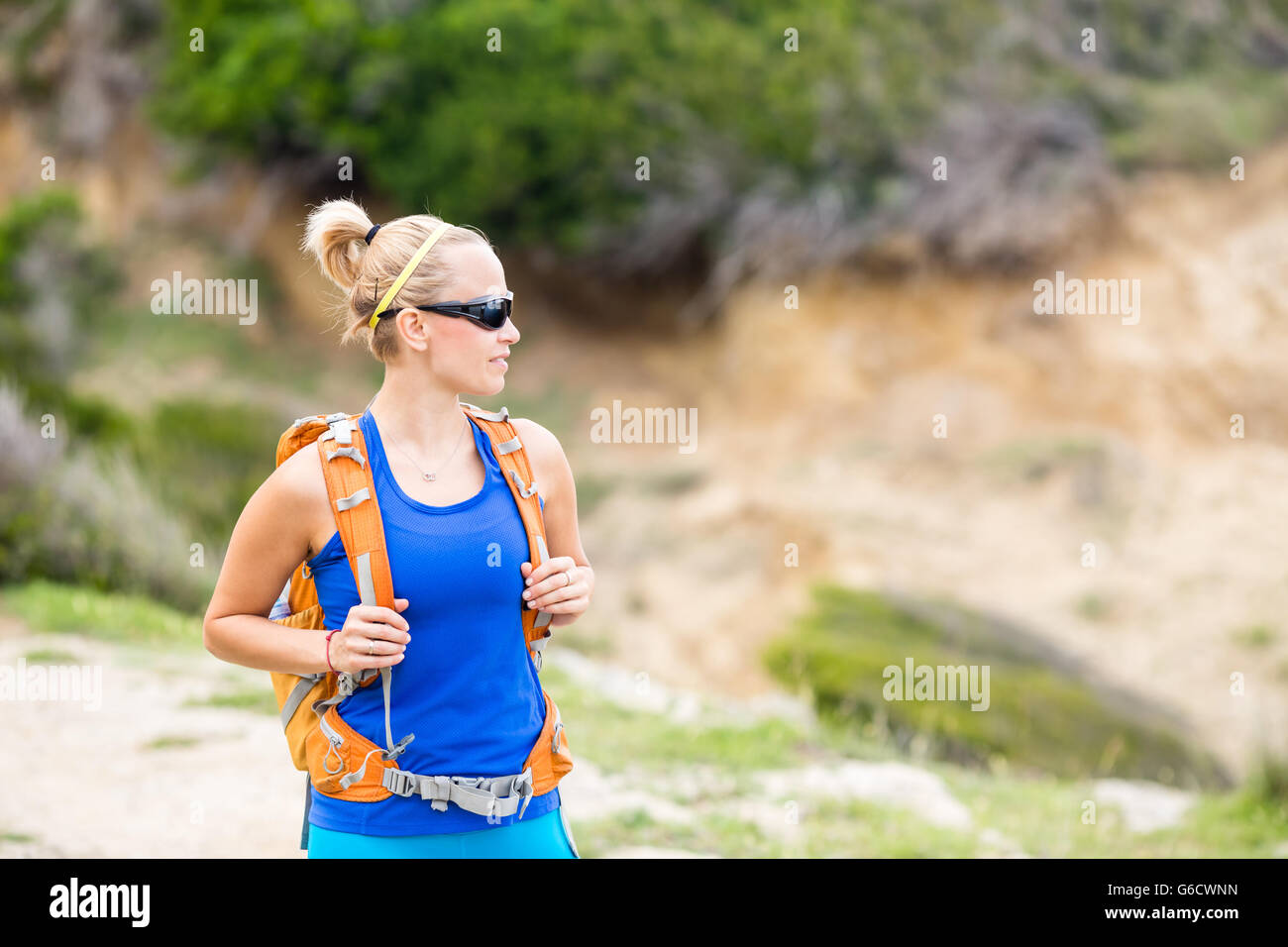 Woman hiking on trail with backpack in mountains. Recreation and ...