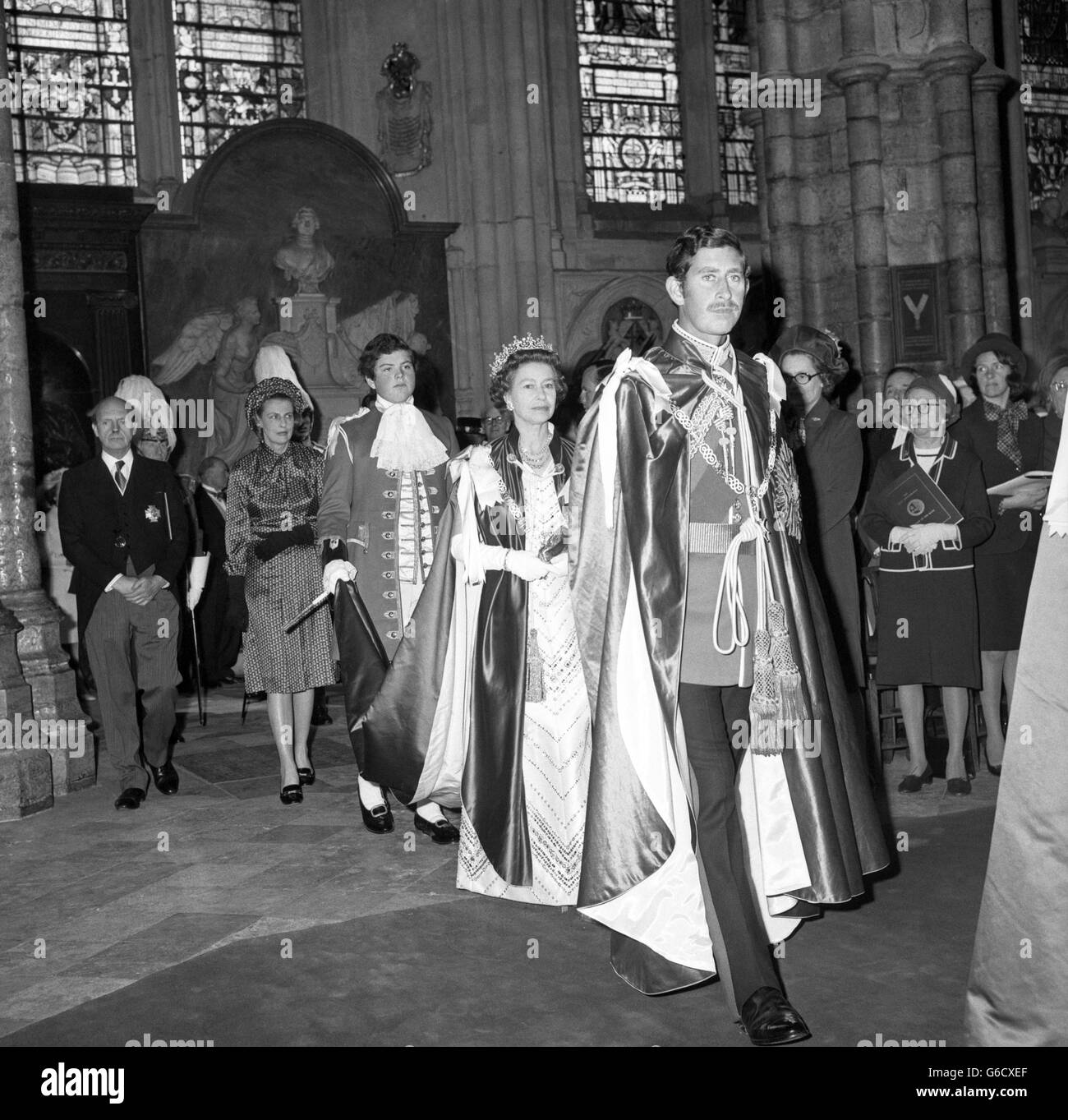 The Prince of Wales walking ahead of the Queen during a procession