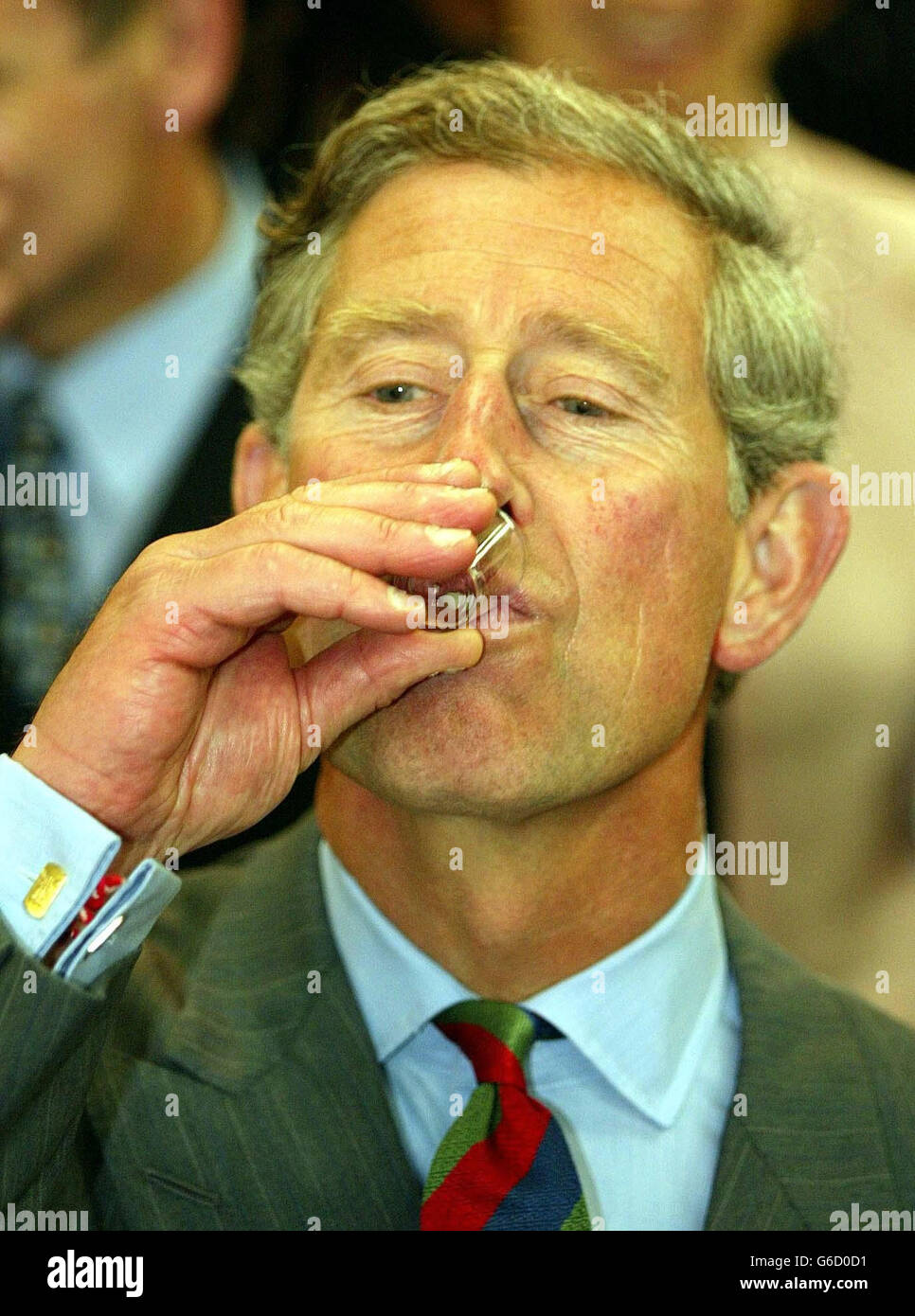 Prince Charles samples a liqueur, during a visit to the Anglesey Food Fair in north Wales. The Prince, and his sone, Prince William , are in Wales for the day. * Tasting three glasses of two different liqueurs, Prince William joked with his father that photographers were trying to get him drunk. Stock Photo