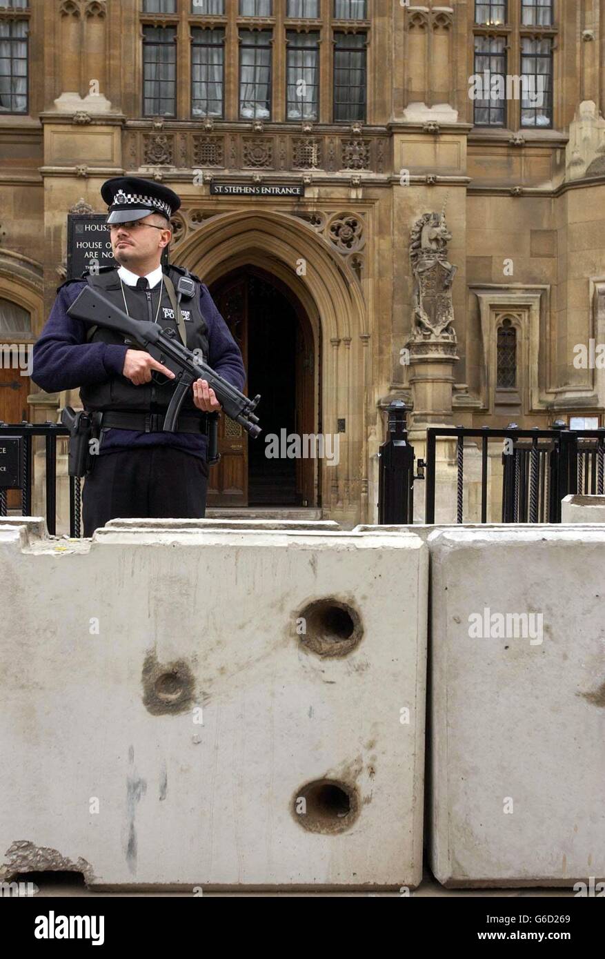 An armed policeman stands behind the new concrete blocks outside the Palace of Westminster in London, which were placed overnight to protect against terrorist vehicles.The concrete blocks have been put in place for the nine-day Whitsun recess which begins, parliamentary officials said. 24/10/04: A top-secret report on security at the Palace of Westminster has recommended electric fences, road-blocks and a barrage on the Thames to protect MPs. The Sunday Times said that it had received a leaked copy of the document drawn up by MI5 and the Metropolitan Police in the wake of a series of Stock Photo