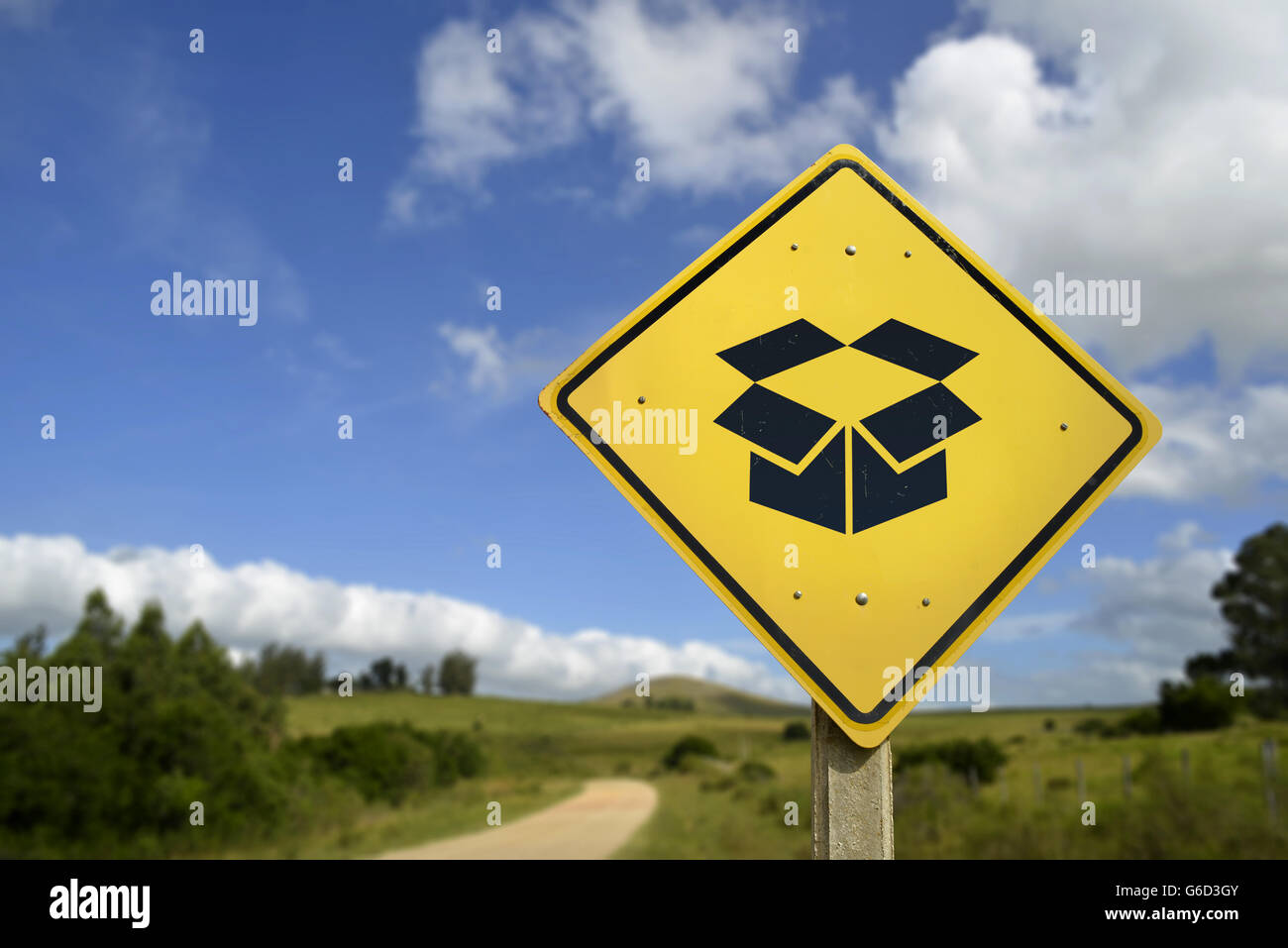 Fast package delivery service anywhere concept. Road sign with open box icon in rural environment, includes copy space. Stock Photo