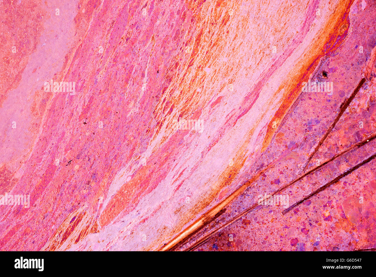 Colorful liquid paint spill background in high contrast pink rainbow colors, abstract texture art backdrop. Stock Photo