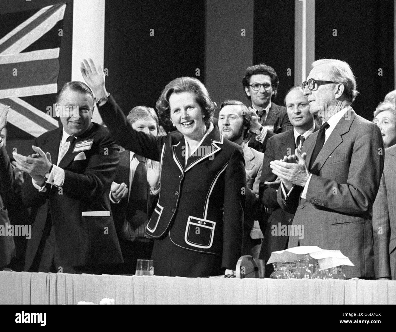 Prime Minister Margaret Thatcher, making her first appearance at the Conservative Party conference, receives a warm welcome on arrival at the Winter Gardens, Blackpool. Joining in the applause are Mr Francis Pym, (left), Secretary of State for Defence and Foreign Secretary Lord Carrington (right). Stock Photo