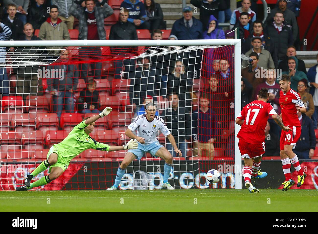 West Ham United goalkeeper Jussi Jaaskelainen saves a shot from Southampton's Pablo Osvaldo (right) Stock Photo