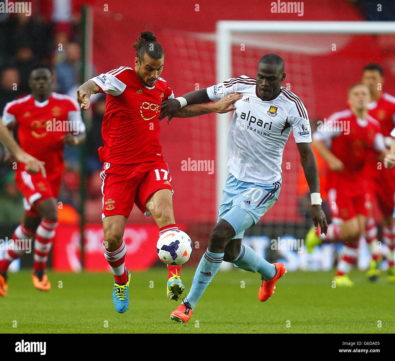 Southampton's Pablo Osvaldo (left) and West Ham United's Guy Demel battle for the ball Stock Photo