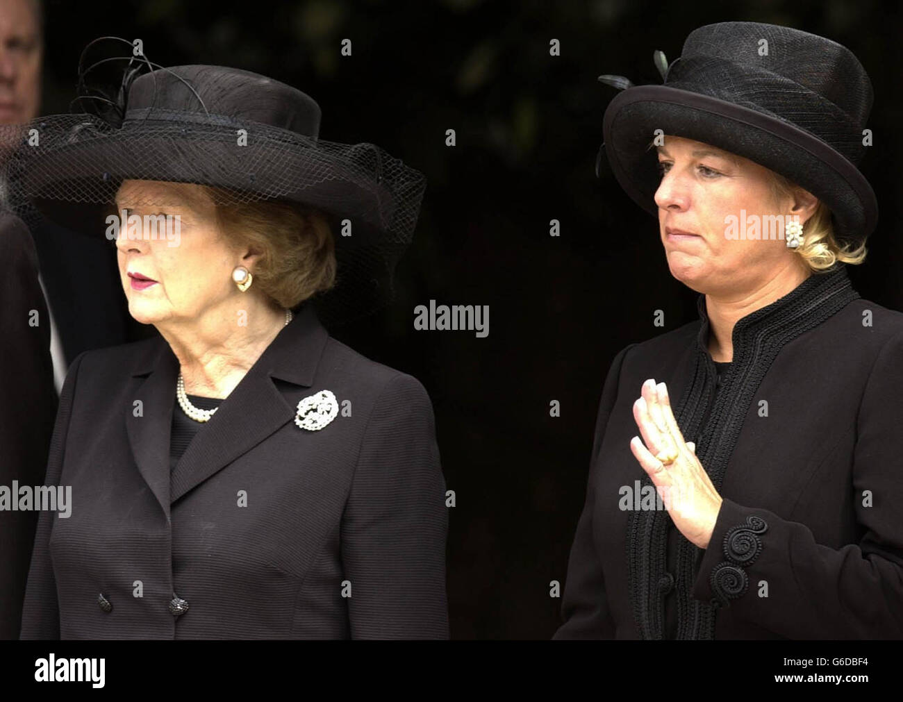 Former Prime Minister and widow of Sir Dennis Thatcher Baroness Thatcher (left) stands with her daughter Carol, who waves goodbye to her father as his coffin is carried from the chapel at the Royal Hospital in Chelsea, west London. *... Sir Denis, 88, died in the Lister Hospital, London on June 26 after a short illness. In January he underwent a six-hour heart by-pass operation from which he seemed to be recovering, before falling ill again in mid-June. Stock Photo