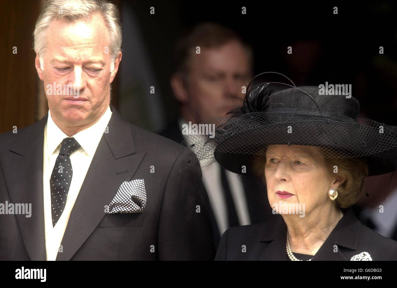 Former Prime Minister Baroness Thatcher stands with her son Mark as the coffin of her husband Sir Denis Thatcher is carried from the chapel at the Royal Hospital in Chelsea, west London. *... Sir Denis, 88, died in the Lister Hospital, London on June 26 after a short illness. In January he underwent a six-hour heart by-pass operation from which he seemed to be recovering, before falling ill again in mid-June. Stock Photo