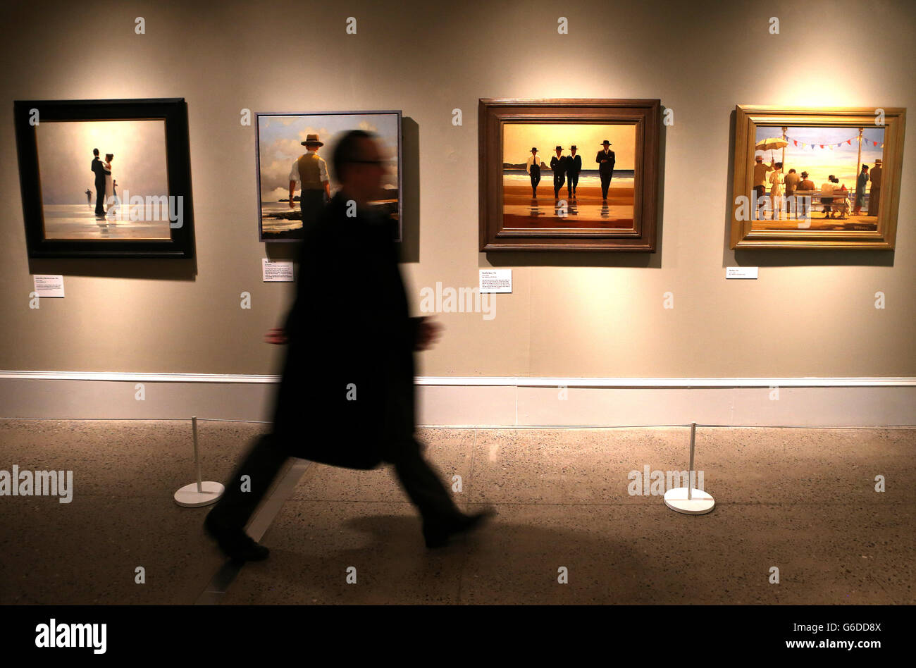 A person walks past the painting The Billy Boys by Jack Vettriano at