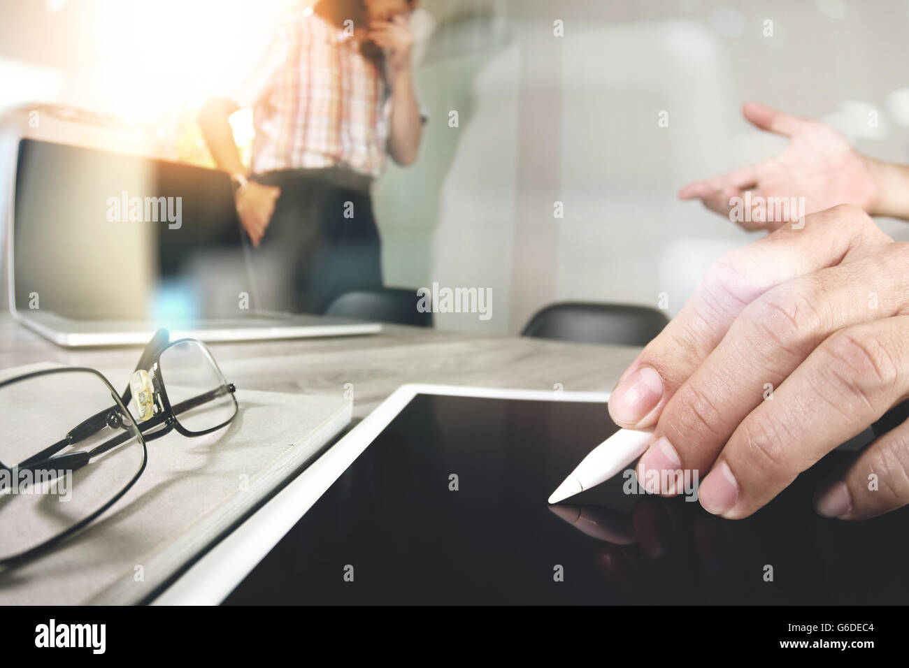 Businessman making presentation with his colleagues and business tablet ...