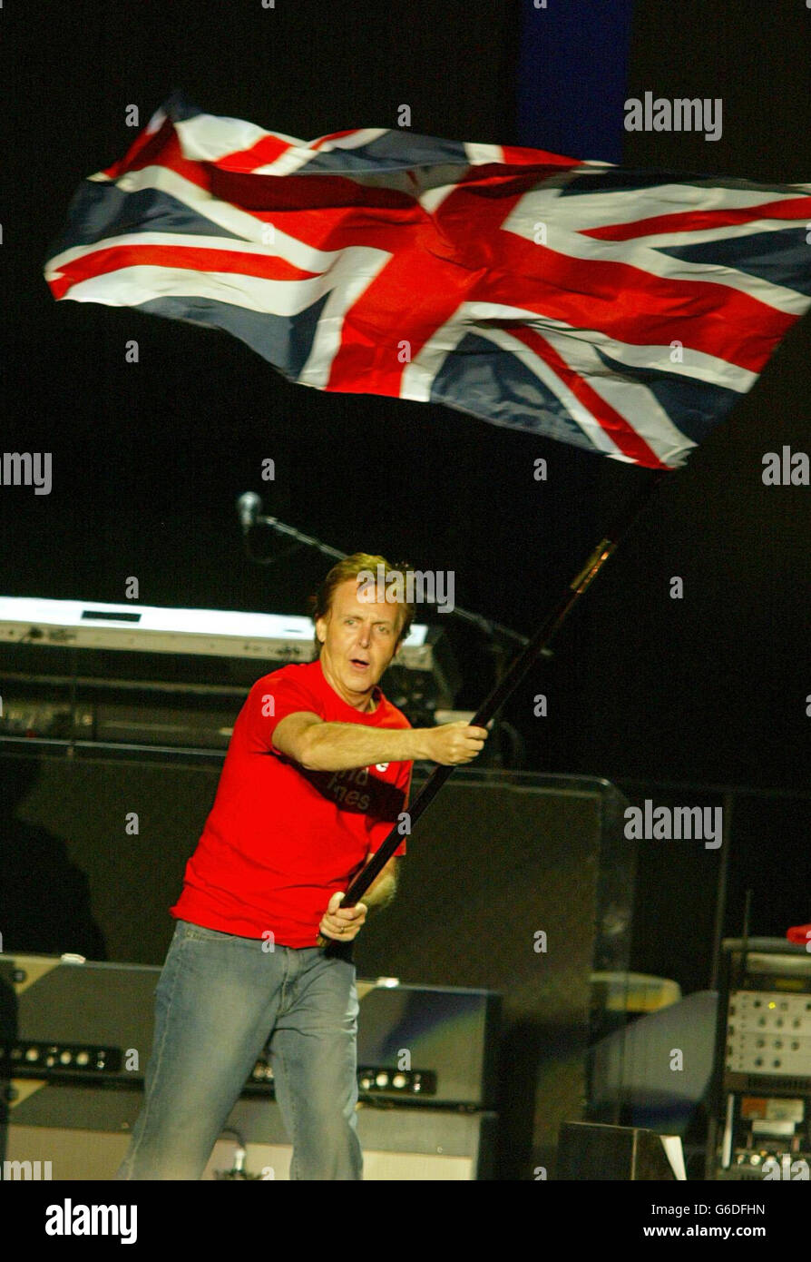 Sir Paul McCartney waves a Union flag at the end of his concert at Kings Dock. 30,000 McCartney fans descended on Liverpool for the final concert of the ex-Beatles world tour, which Sir Paul dubbed his home-coming. * The gates opened at 5.30pm but hundreds of fans queued for hours in advance to secure standing places at the front of the purpose-built open air arena. Stock Photo