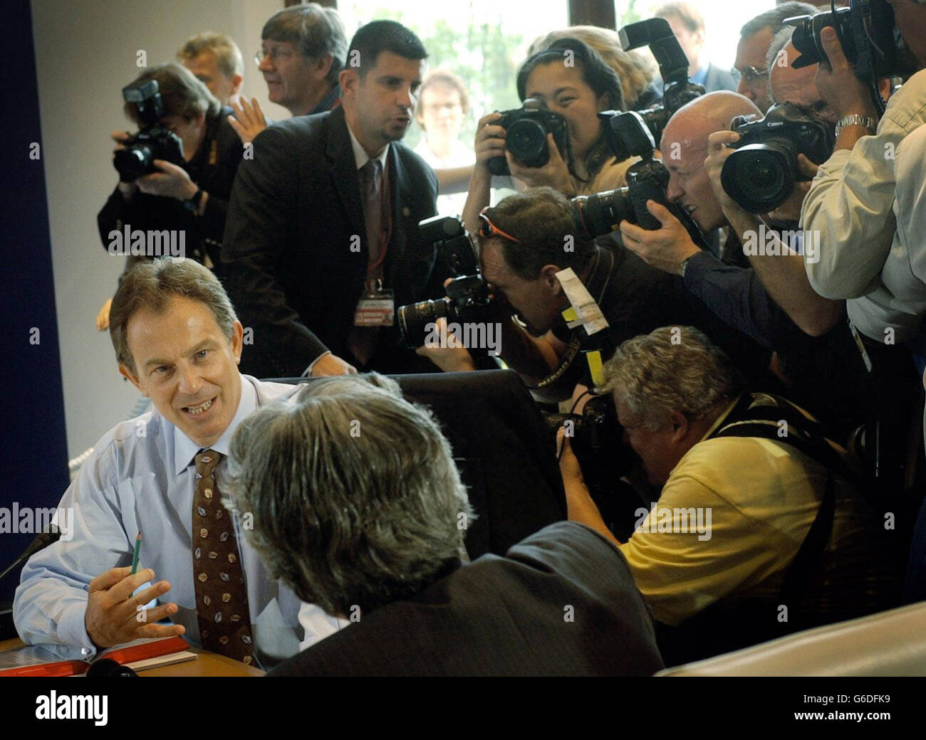 Prime Minister, Tony Blair, talks with his Japanese counterpart Junichiro Koizumi, during a 'round the table' photocall with fellow world leaders of the G8 nations in Evian, France. * Blair was continuing talks today aimed at boosting aid for Africa and agreeing on the threat posed by the potential proliferation of weapons of mass destruction. The Prime Minister was also hoping the G8 summit in Evian, would give added impetus to the Middle East peace process with US President George W Bush due to hold talks later this week with Israeli and Palestinian leaders in Egypt. Stock Photo