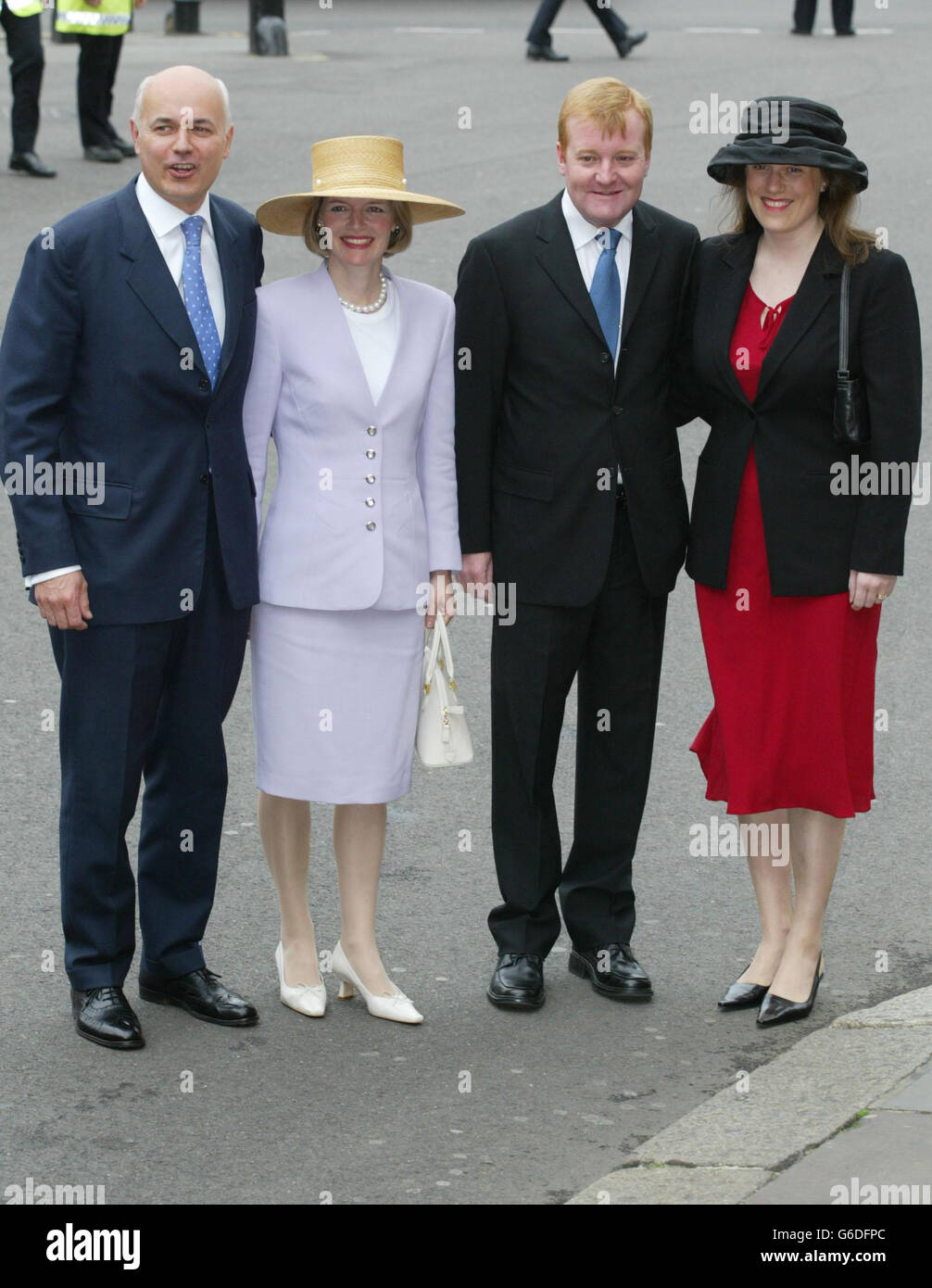 Iain Duncan Smith (left), leader of the Conservative Party and his wife Betsy arrive with the leader of the Liberal Democrat Party, Charles Kennedy and his wife, Sarah, at Westminster Abbey for a service to celebrate the 50th anniversary of the coronation. * of Queen Elizabeth II. 16 senior members of the Royal family and other VIPs were among the congregation with some 1,000 members of the public, including 34 'Coronation babies' born on June 2, 1953 and celebrating their 50th birthdays. In the afternoon, The Queen is attending a children's tea party in the garden of Buckingham Palace. Stock Photo