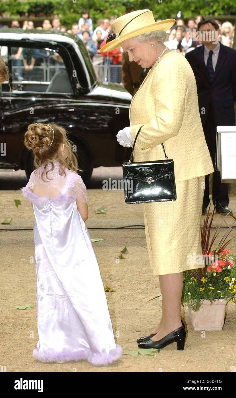 Nine-year-old Louisa Harrington from Clevedon, who suffers with Cardiomyopathy, talks to Queen Elizabeth II after presenting her with a crown of flowers on the Mall, London, celebrating the 50th anniversary of the Coronation. Stock Photo