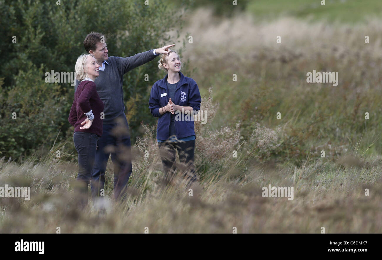 Liberal Democrats leader Nick Clegg with Scottish Wildlife Trust Head of Policy Dr Maggie Keegan (left) and Cathkin Marsh Project officer Laura Cunningham (right) during a visit to Cathkin Marsh near Glasgow as the Liberal Democrats' autumn conference gets underway in Glasgow, Scotland. Stock Photo
