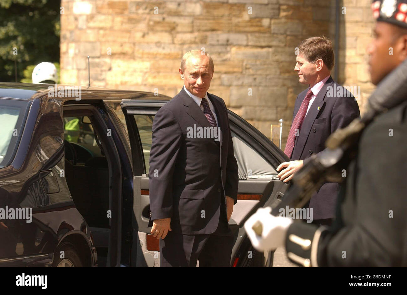 Russian President Vladimir Putin arrives at the Palace of Holyrood House in Edinburgh, for a private lunch. As President Putin's entourage passed through the gates a protester threw himself in front of the President's car. * The demonstrator, who was shouting slogans attacking the war in Chechnya, was wrestled to the ground by police officers and taken away for questioning. Stock Photo
