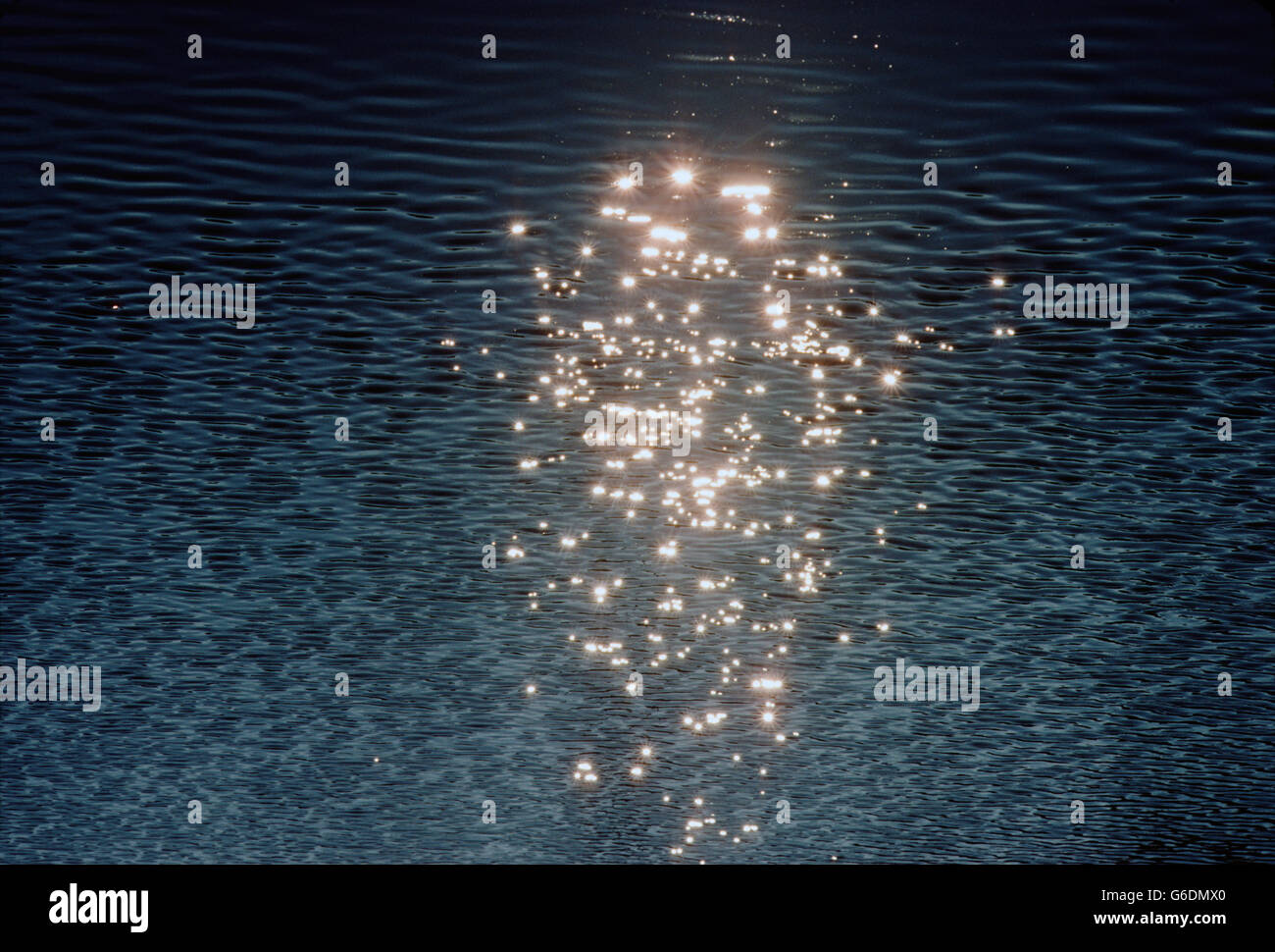 Aerial view of sun reflecting off ripples of water in a lake Stock Photo