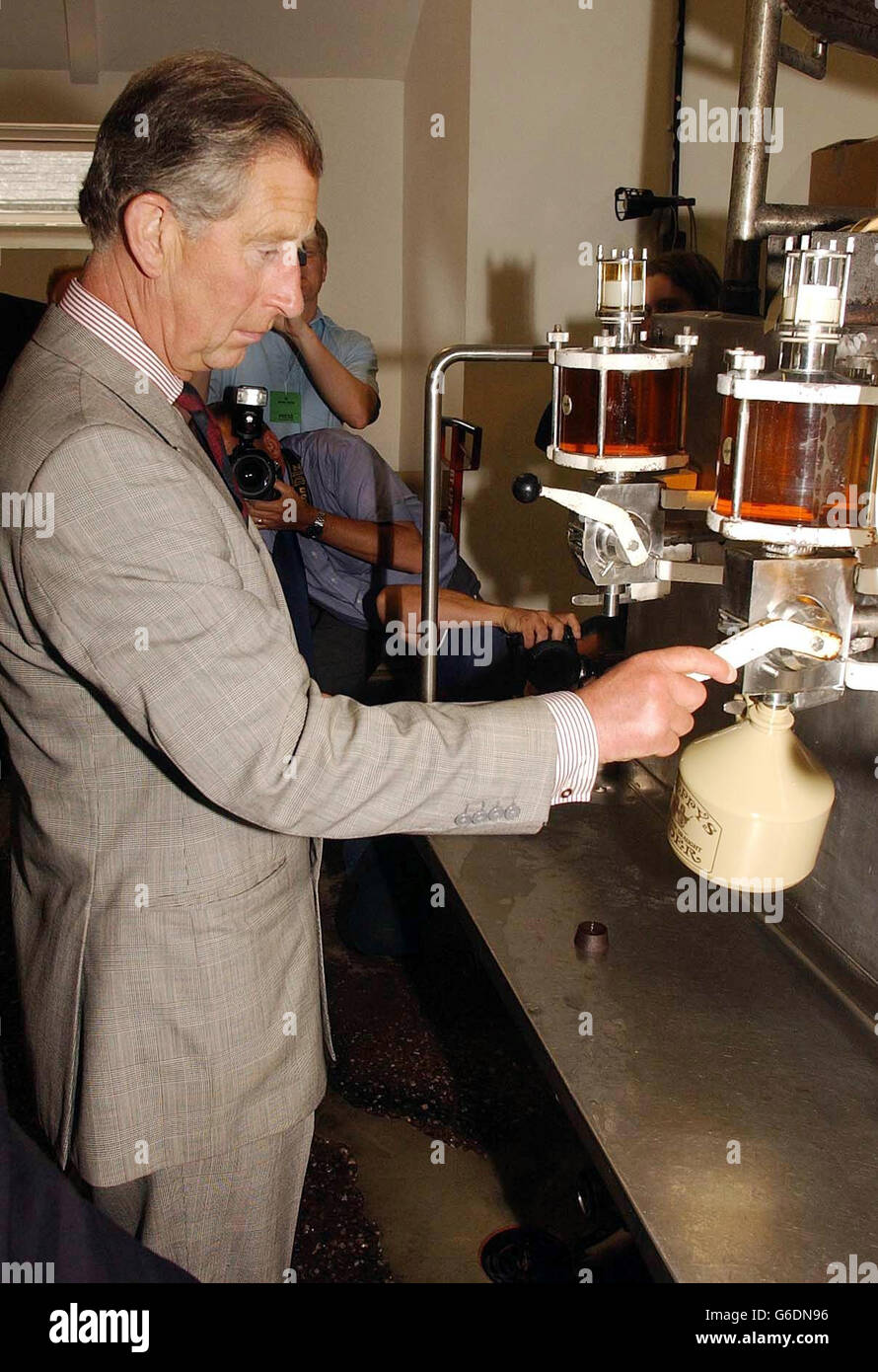 The Prince of Wales pulls a pint or two of cider at at Sheppy's Cider Farm Centre, outside Taunton Somerset. The Prince was also shown around a rural life museum, housing antique agricultural and cider making tools. Stock Photo