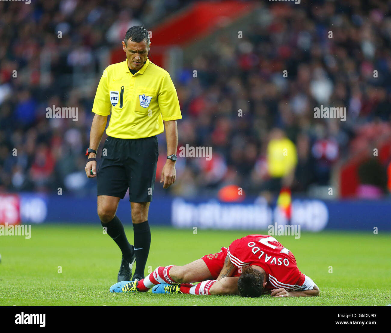 Southampton's Pablo Osvaldo lies in the pitch as referee Andre Marriner looks on Stock Photo