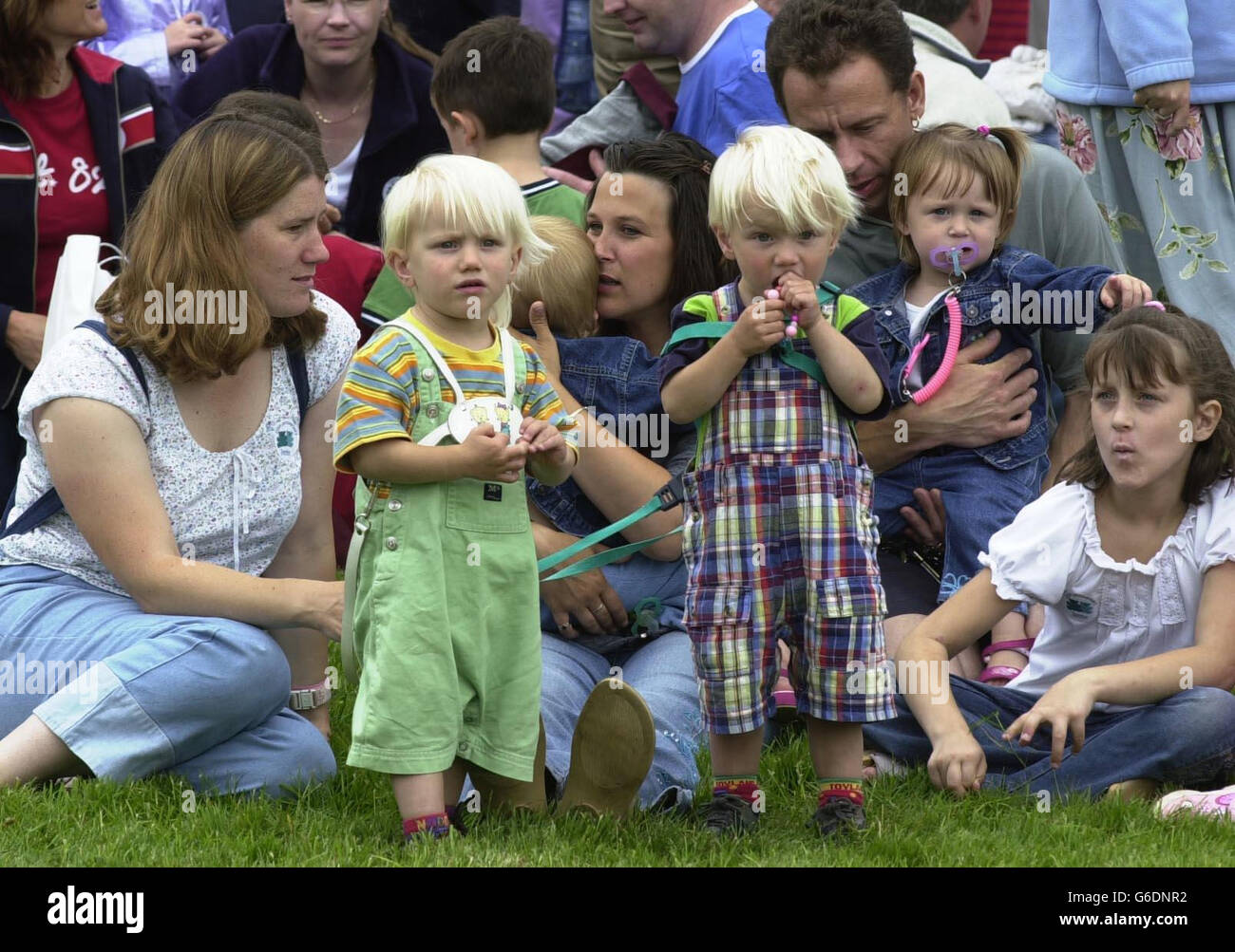 (l-r) Twin brothers Indie and Dominic Payne, 2, from Kidlington in Oxfordshire, observe a gathering of twins and multiple birth families organised by the Twins & Multiple Births Association (Tamba) at Blenheim Palace in Oxfordshire. * The national charity Tamba was organising the biggest ever gathering of twins and triplets in the UK to celebrate 25 years of supporting multiple birth families. Stock Photo