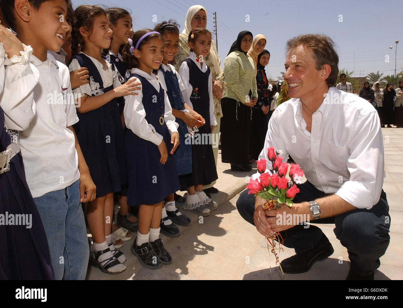 The British Prime Minister, Tony Blair, is greeted by school children