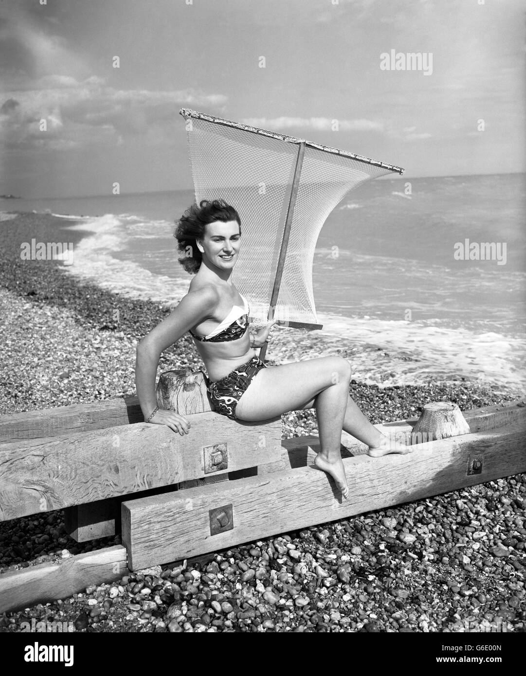 22-year-old Joan Knight strikes a pose on Cooden beach in Bexhill, Sussex. Stock Photo