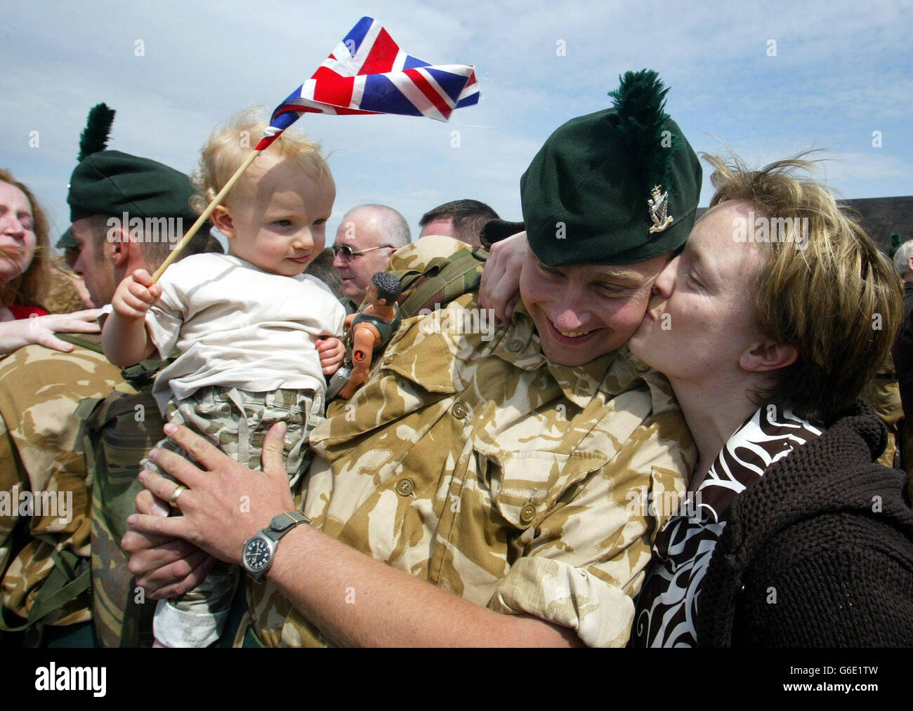 Ranger Mark Wooley from Newtownards Co Down, greets his 18 month old son, Steven, and wife Alison on arrival at RAF Aldergrove in Belfast. He was one of thirty-three soldiers from the Royal Irish Rangers, who guarded 16 Air Assault Brigade headquarters during the Gulf conflict. *..During the war they had earned huge respect from the Regular Army for the vital security work they carried out. Lieutenant Colonel Andrew McCord, commanding officer of the Royal Irish Rangers, said officers had been unable to distinguish between full-time and TA soldiers during the war. Stock Photo