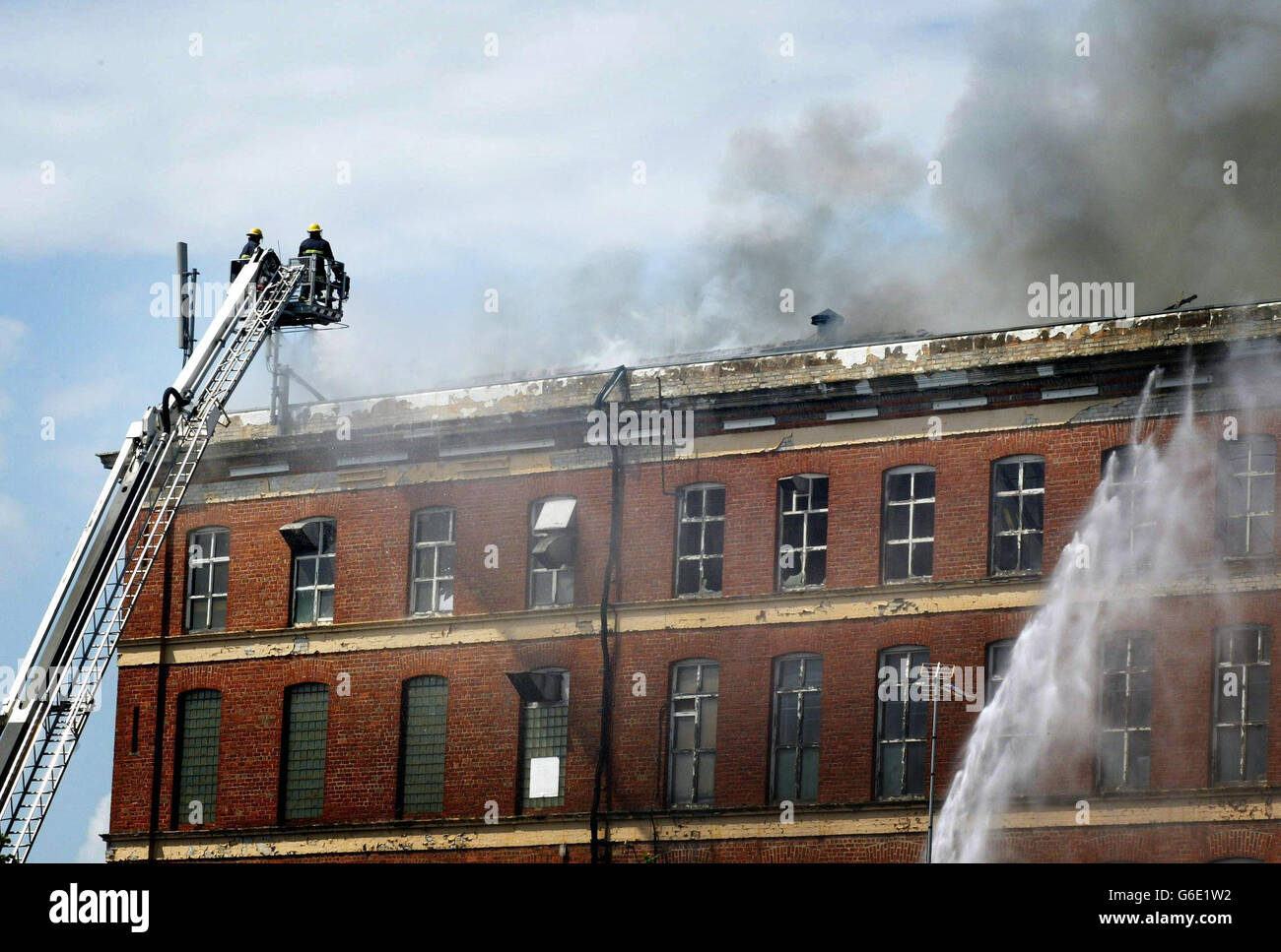 Fire crews tackle a blaze at an industrial complex in the north of Belfast. Premises in Edenderry Industrial Estate on Belfast's Crumlin Road were evacuated as firefighters dealt with the blaze. * Safety experts were expected to make an assessment of whether the old mill building, whose entire fourth floor was destroyed, should be demolished. Stock Photo
