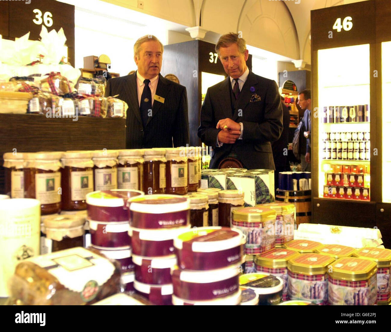 Prince Charles looks round a shop trading in Scotch produce with Alastair McIntosh chairman of the Scotch Whisky Appreciation Society whilst on a tour of the Scotch Whisky Heritage Centre on the royal mile to celebrate British Tourism as part of Royal Tourism Day. Stock Photo