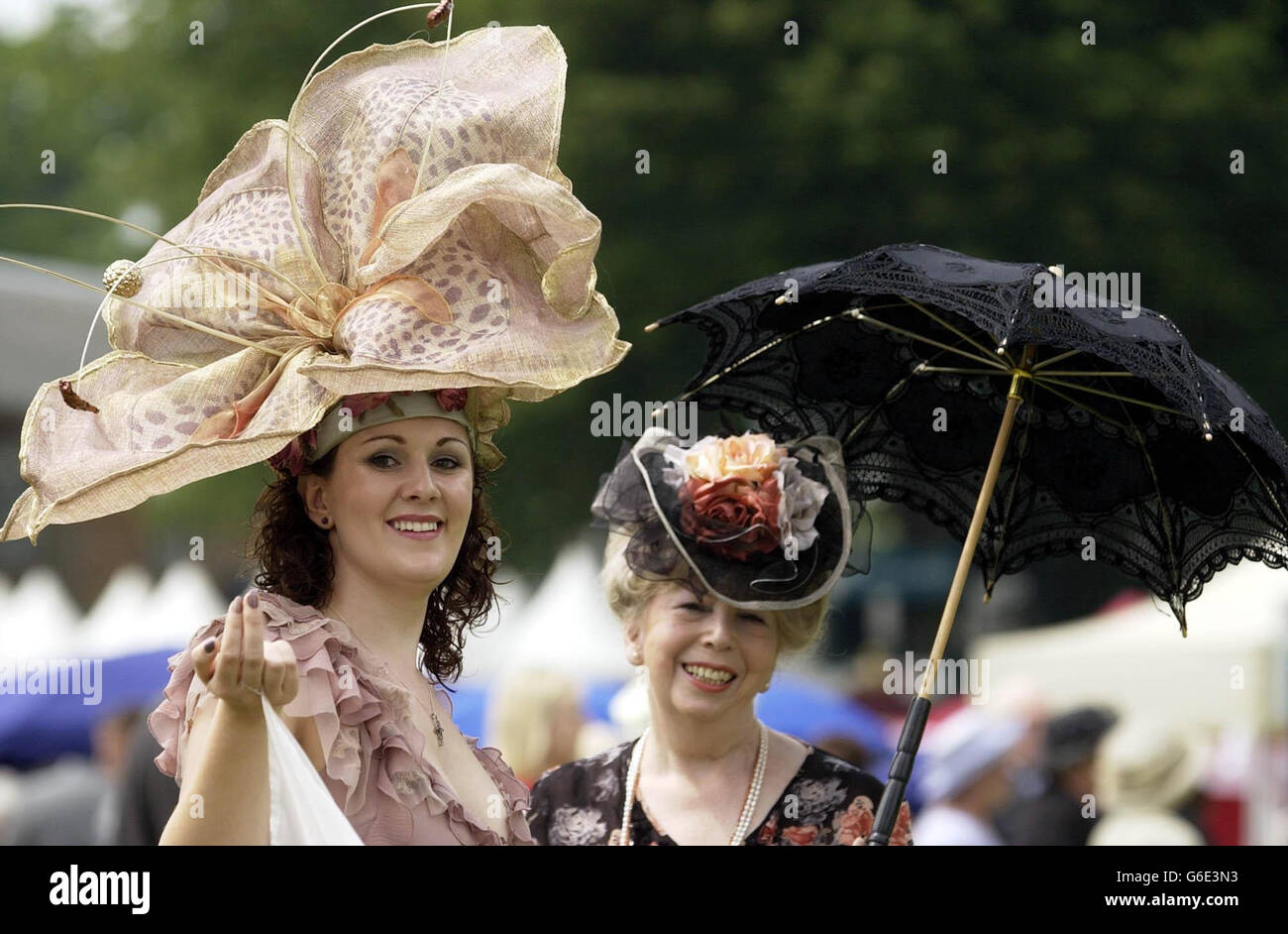 Val Gutteridge (right) the designer behind the hat-maker 'Over the Top'  stands with Kedra Goodall, who models one of her creations, at Ascot for  the first day of the Royal Ascot. The