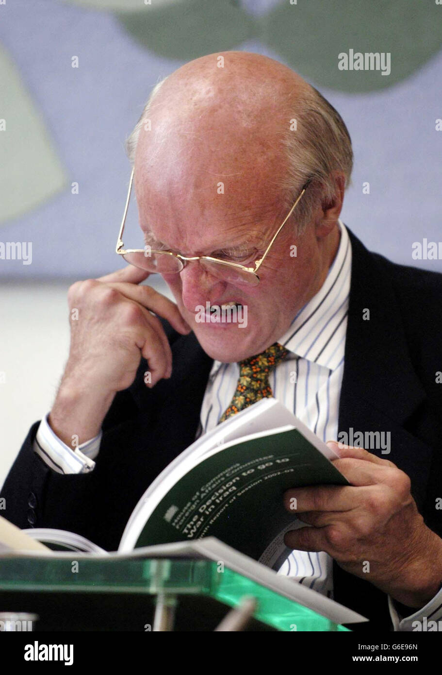 The Chairman of the Foreign Affairs Committee, Donald Anderson, reads 'The decision to go to war in Iraq' Ninth Report of session 2003, during a press conference held at Portcullis House. * The committee today concluded the Government undermined the credibility of its case for war by producing the second 'dodgy' dossier on Iraq s weapons. The document was published on February 3, two weeks before MPs voted on whether to send British troops to war Stock Photo