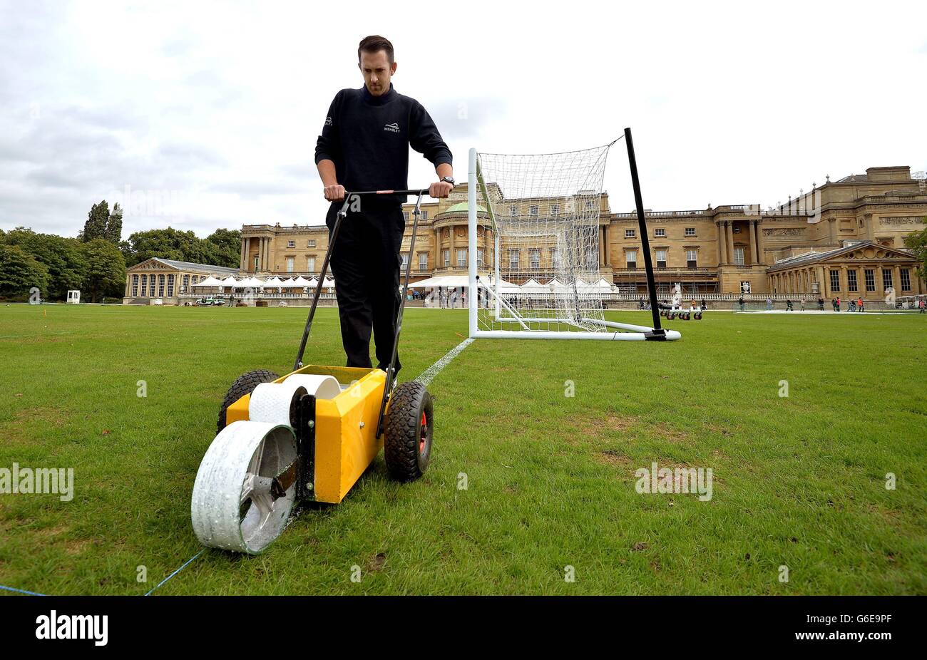 Karl Standley, a groundsman at Wembley Stadium, marks out the the lines