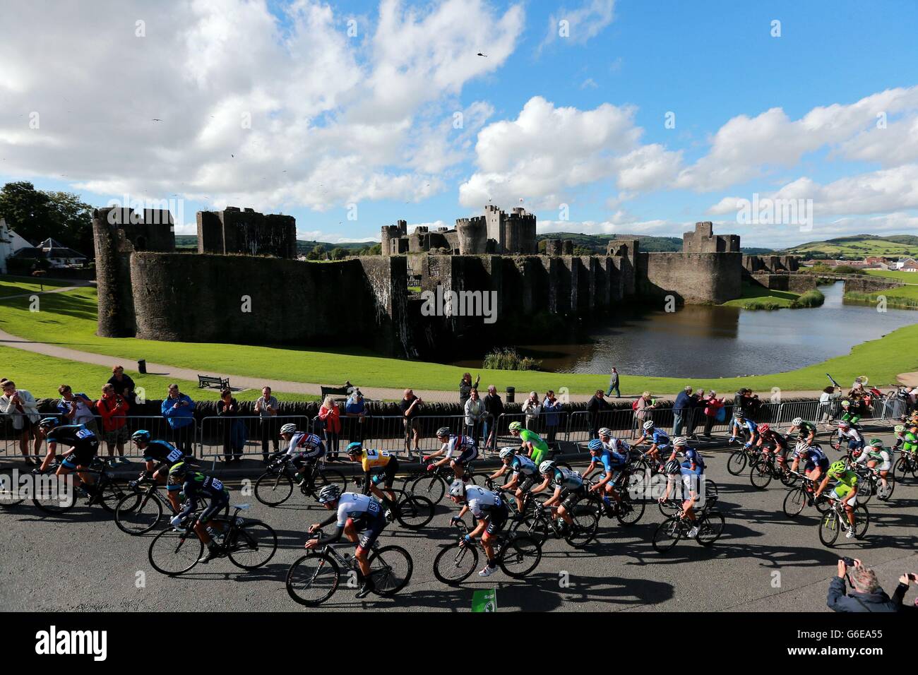 Sir Bradley Wiggins (yellow jersey) rides in the centre of the Peloton as they pass Caerphilly Castle during Stage Five of the 2013 Tour of Britain from Machynlleth to Caerphilly. Stock Photo