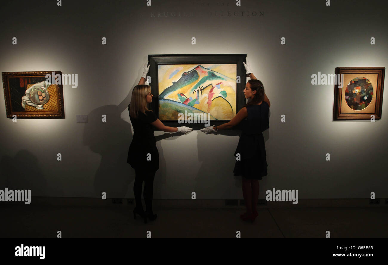 Christie's employees pose next to Wassily Kandinsky's 'Herbstlandschaft' that is expected to fetch twenty million US dollars in a sale of works from the Jan Krugier Collection. Stock Photo