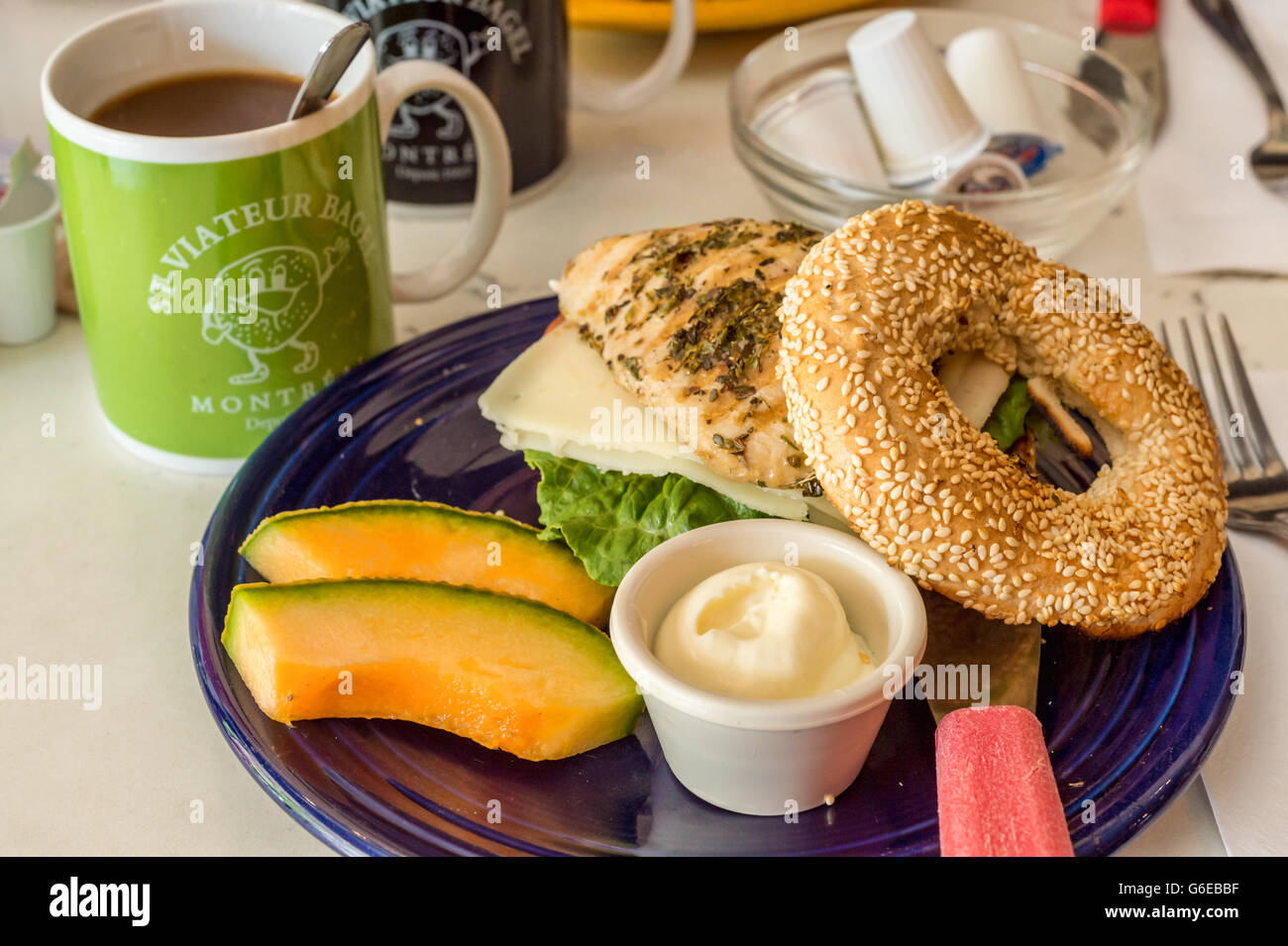 Bagels on a plate with chicken, cheese, cream and melon at Bagel St-Viateur restaurant in Montreal, Canada Stock Photo