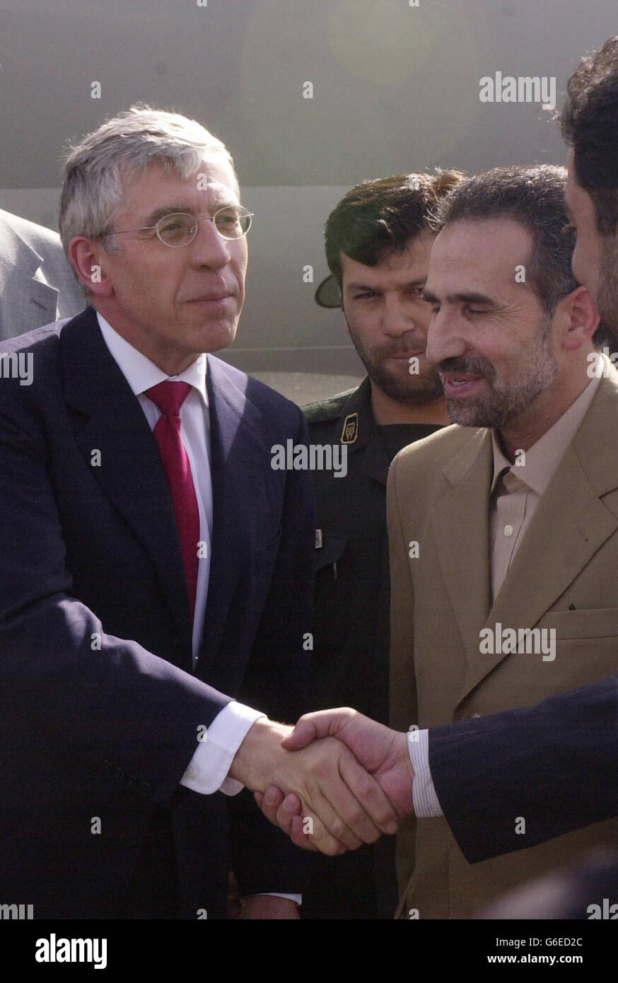 Britain's Foreign Secretary Jack Straw is greeted by Iranian officials