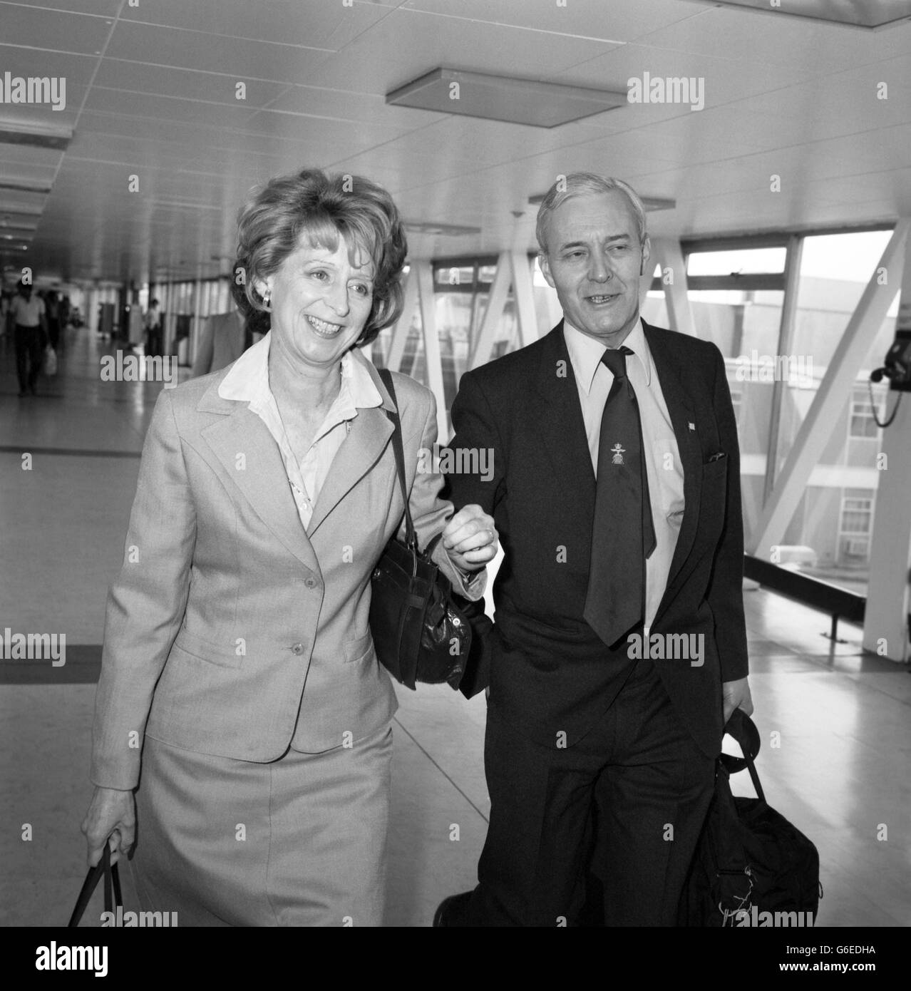 Labour MP, Mr Tony Benn, and his American-born-wife, Caroline, at Heathrow airport, London, prior to flying out to New York, where Benn is due to make a speech at the Smith and Hobart College in Geneva, New York State. He is expected to claim strong support in Britain for an unconditional and immediate cease fire in the Falklands conflict. Stock Photo