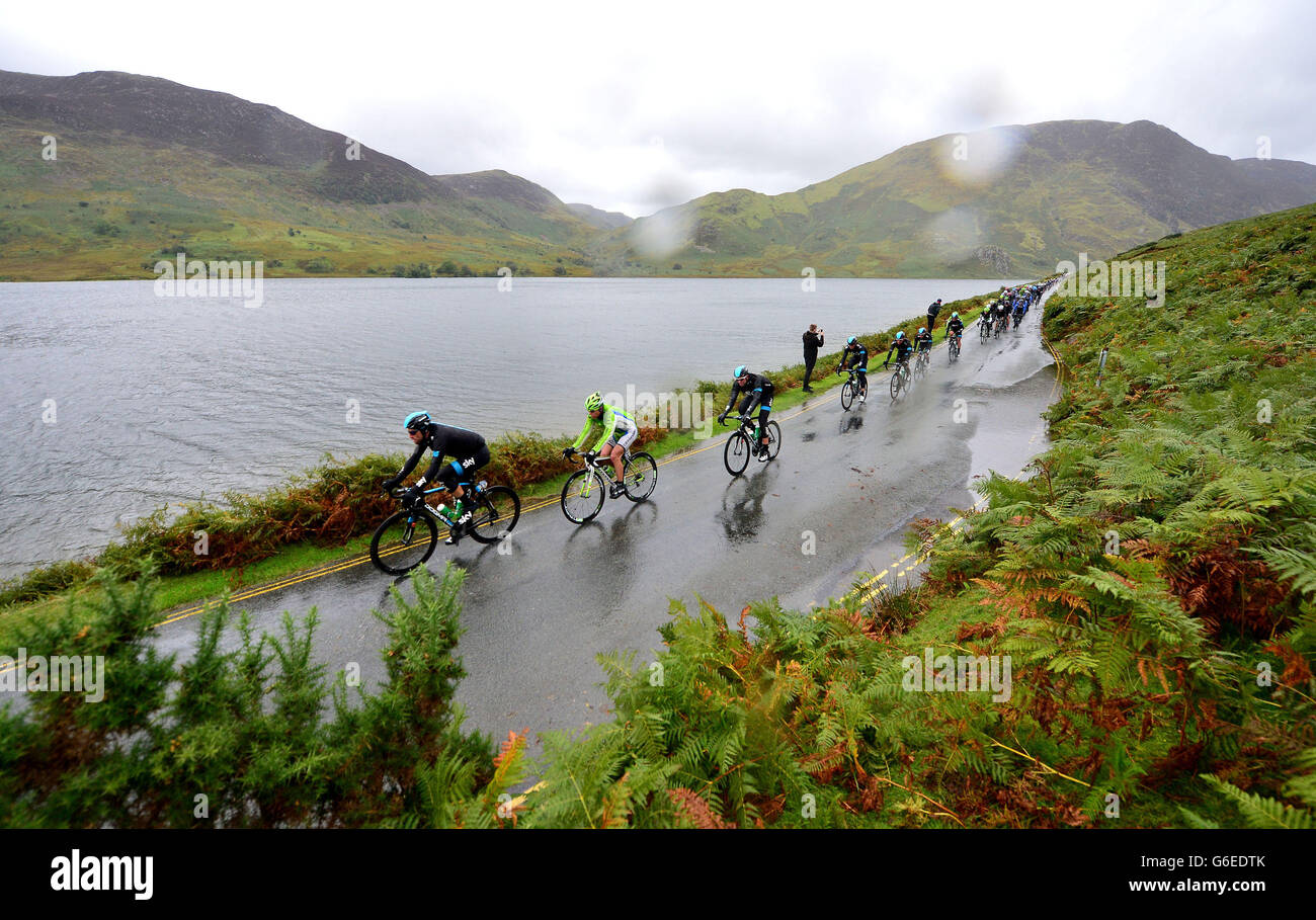 Cycling - 2013 Tour of Britain - Stage Two - Carlisle to Kendal. The peloton passes Crummock Water near Keswick, during the second stage of the 2013 Tour of Britain from Carlisle to Kendal. Stock Photo