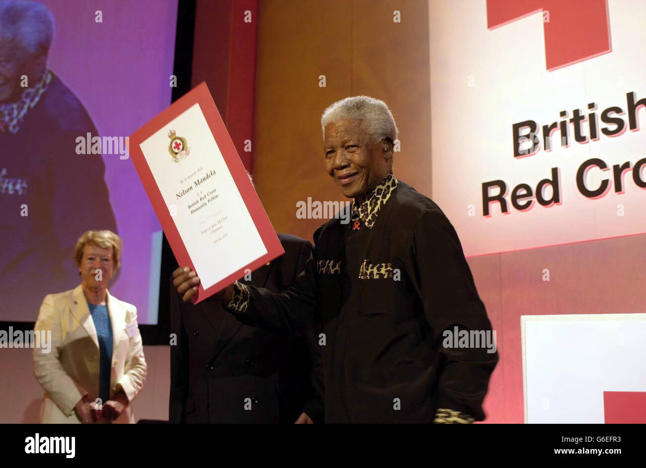 Former South African President Nelson Mandela collects his Red Cross Humanity Fellowship Award after having delivered a lecture in aid of the British Red Cross at the Queen Elizabeth II Conference Centre in central London. * Mr Mandela was presented with the Red Cross Humanity Fellowship Award by Dr Jacques Moreillon, the Red Cross delegate who visited Mr Mandela in prison in the early 1970's. Mr Mandela also highlighted the AIDS crisis in Southern Africa and stressed the need for rapid and real progress in AIDS treatments for all. Stock Photo
