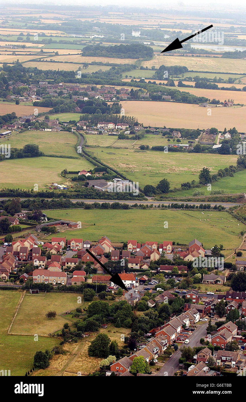 Aerial view which shows the location of the house (arrowed, foreground) of Dr David Kelly in Southmoor, near Abingdon, and a police tent (arrowed top) close to the copse where a body matching his description was found at Harrowdean Hill. * Dr Kelly was named as a possible mole for a BBC report claiming that a dossier on weapons of mass destruction had been 'sexed up'. Stock Photo
