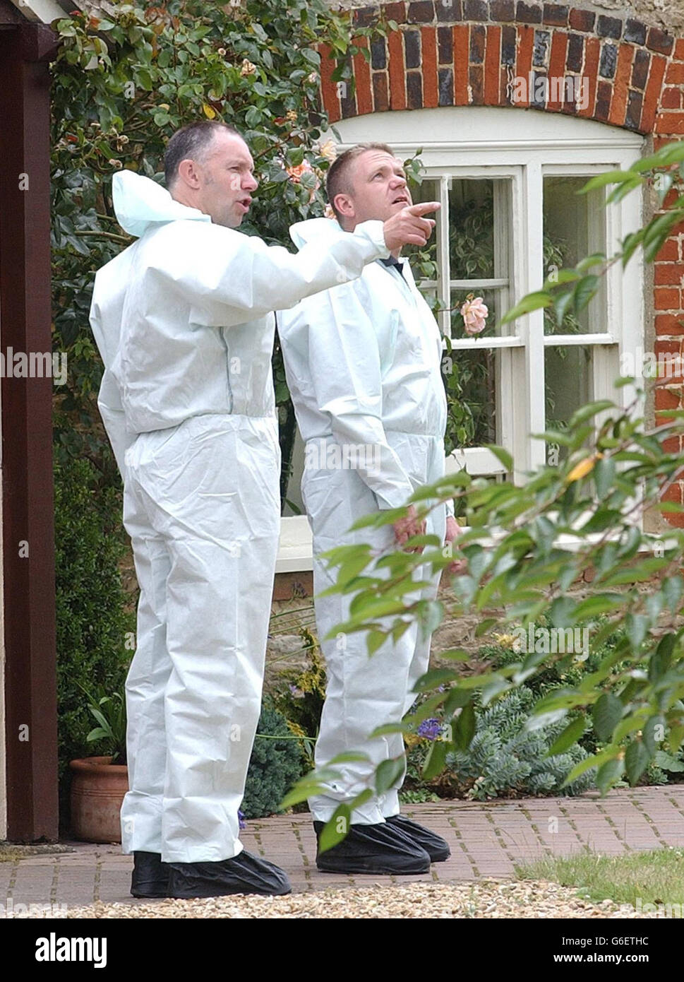 Police forensic officers conduct investigations at the home of Dr David Kelly in Southmoor, Oxfordshire. Earlier two women, believed to be Dr Kelly's wife Janice and one of his three daughters, were driven away from their house in a police vehicle with darkened windows. It is thought police were taking them to the John Radcliffe Hospital in Oxford to formally identify the scientist's body. Stock Photo