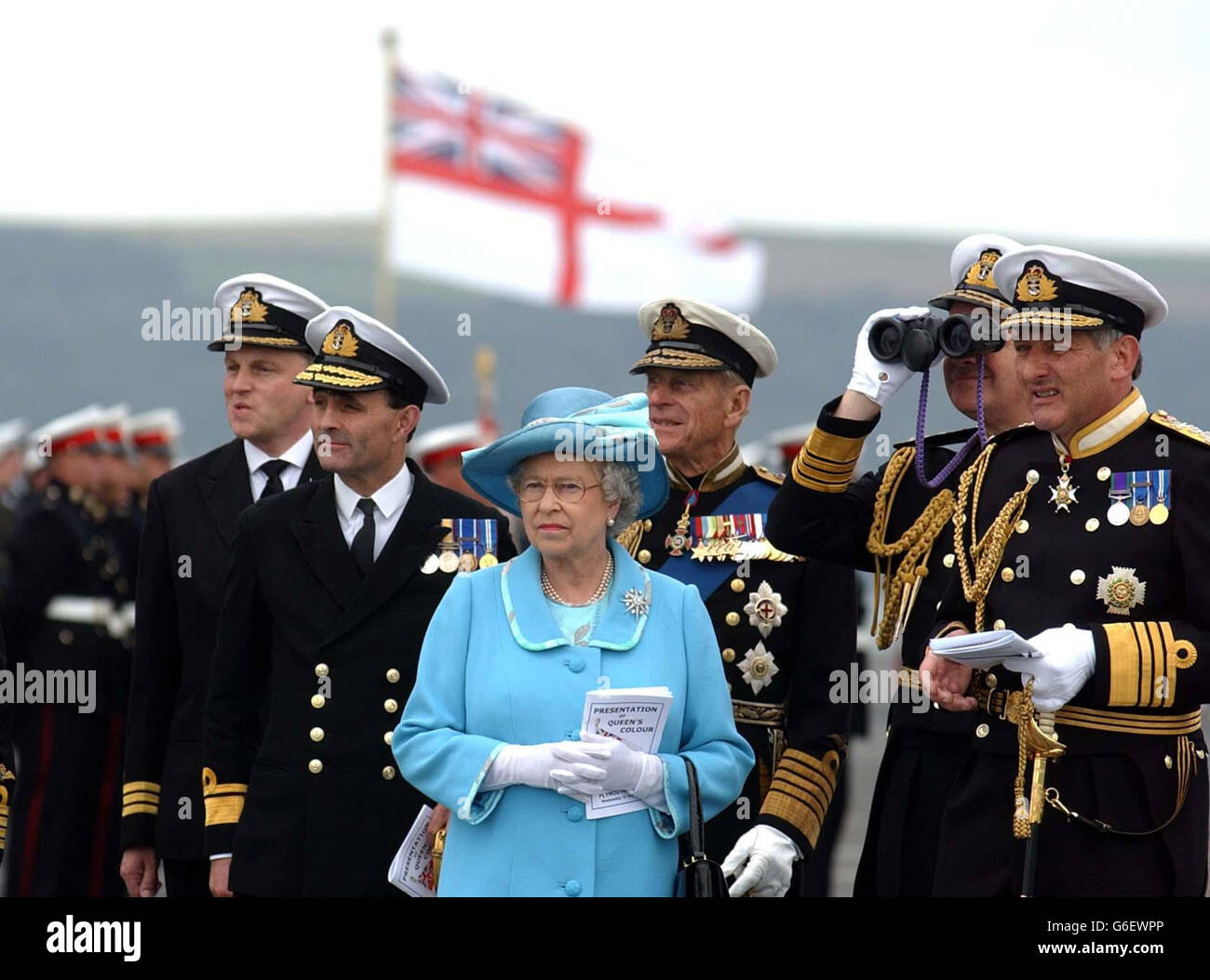 Queen Elizabeth II with the Duke of Edinburgh and high ranking officers on board HMS Ocean to present new Colours in Plymouth Sound. Thousands of onlookers are expected to watch the historic event from land and nearby pleasure boats. * To mark the occasion 18 Royal Navy ships are to stage the biggest Fleet gathering in Plymouth waters for nearly a century. Stock Photo