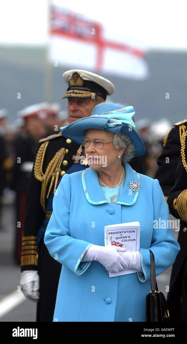 Queen Elizabeth II with the Duke of Edinburgh on board HMS Ocean to present new Colours in Plymouth Sound. Thousands of onlookers are expected to watch the historic event from land and nearby pleasure boats. * To mark the occasion 18 Royal Navy ships are to stage the biggest Fleet gathering in Plymouth waters for nearly a century. Stock Photo