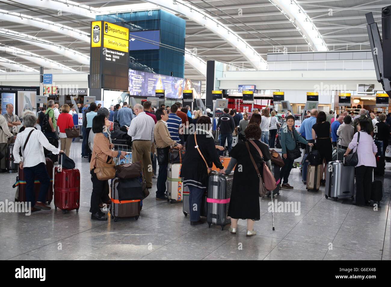 Queues form as British Airways' passengers with check-in luggage were unable to fly from Heathrow's Terminal 5 (T5) due to a computer problem. Stock Photo