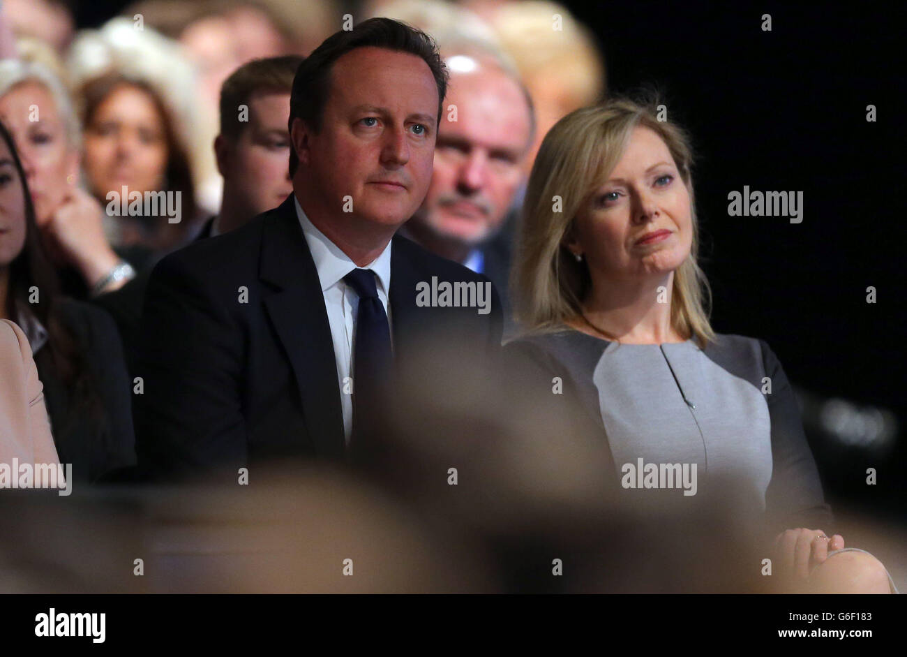 Primie Minister David Cameron and Ffion Hague, wife of Foreign Secretary William Hague, watch as he delivers his speech to delegates on the first day of the Conservative Party Conference at Manchester Central in Manchester. Stock Photo