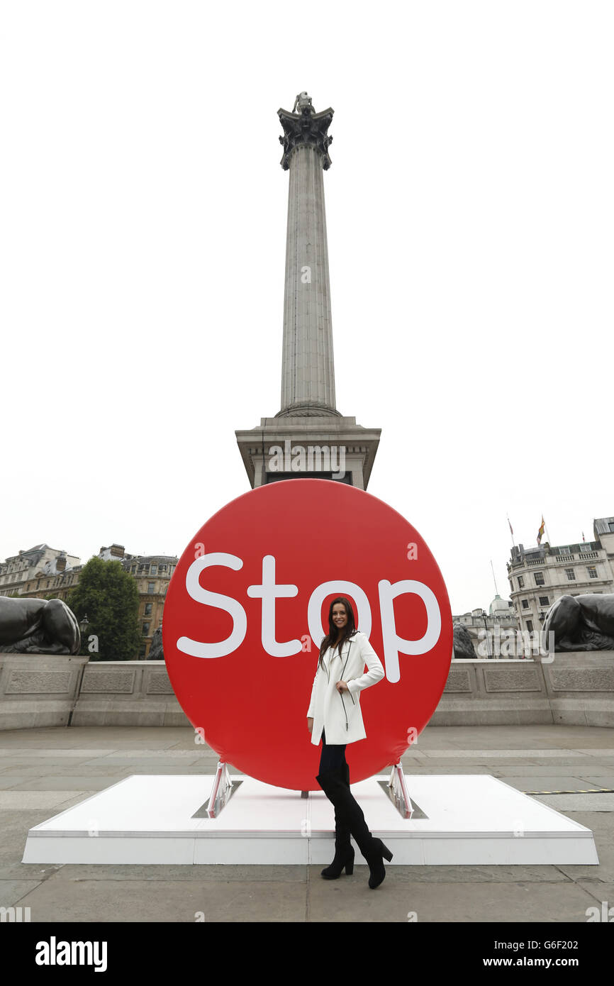 Actress Kelsey-Beth Crossley stands before a three metre high disk in Trafalgar Square, London, to launch 'Stoptober', a campaign to get people to give up smoking. Stock Photo