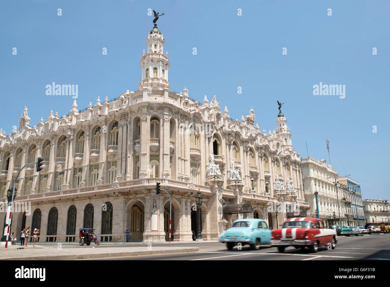 Classic cars driving past The Gran Teatro in Havana, Cuba Stock Photo