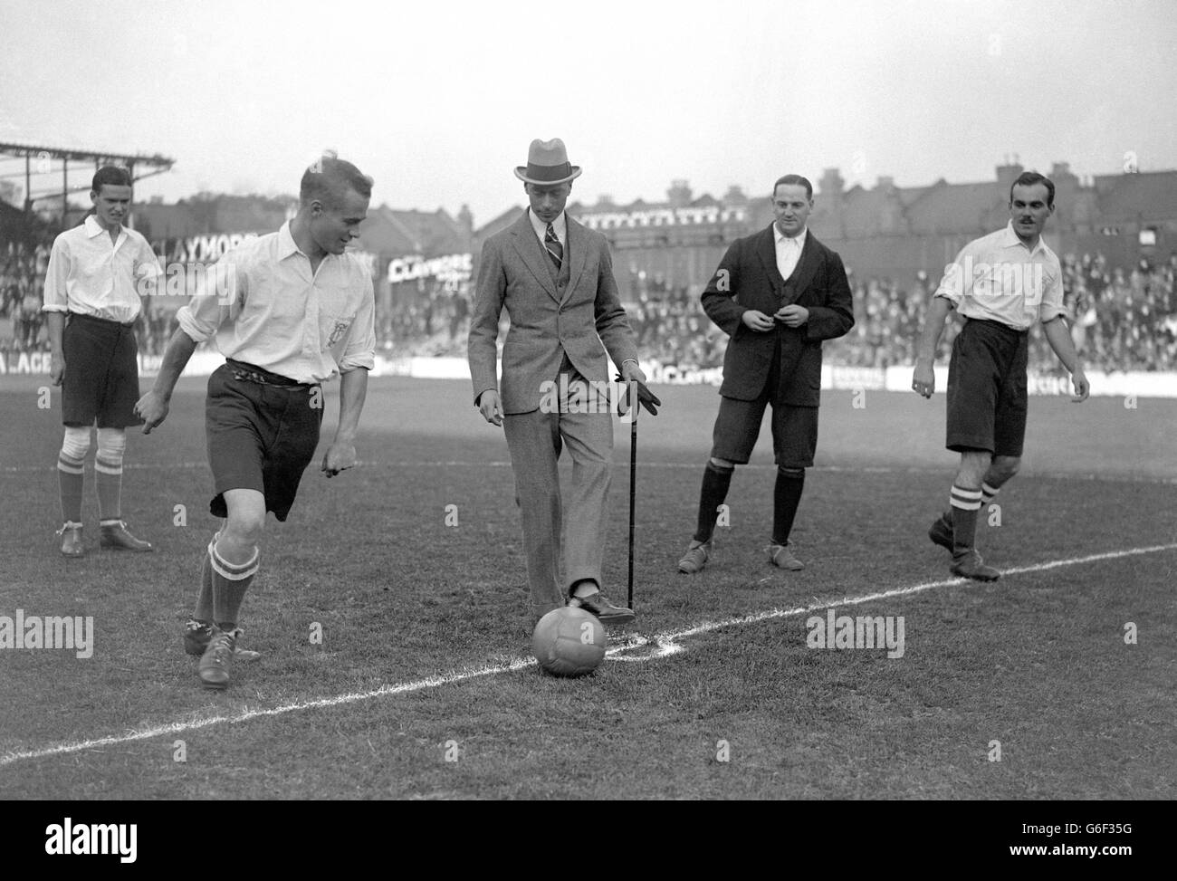 The Duke of York kicks off a game between Tottenham Hotspur and Corinthian XI. The match was played in aid of the Dockland Settlement and Malburn College Boys Club. Stock Photo